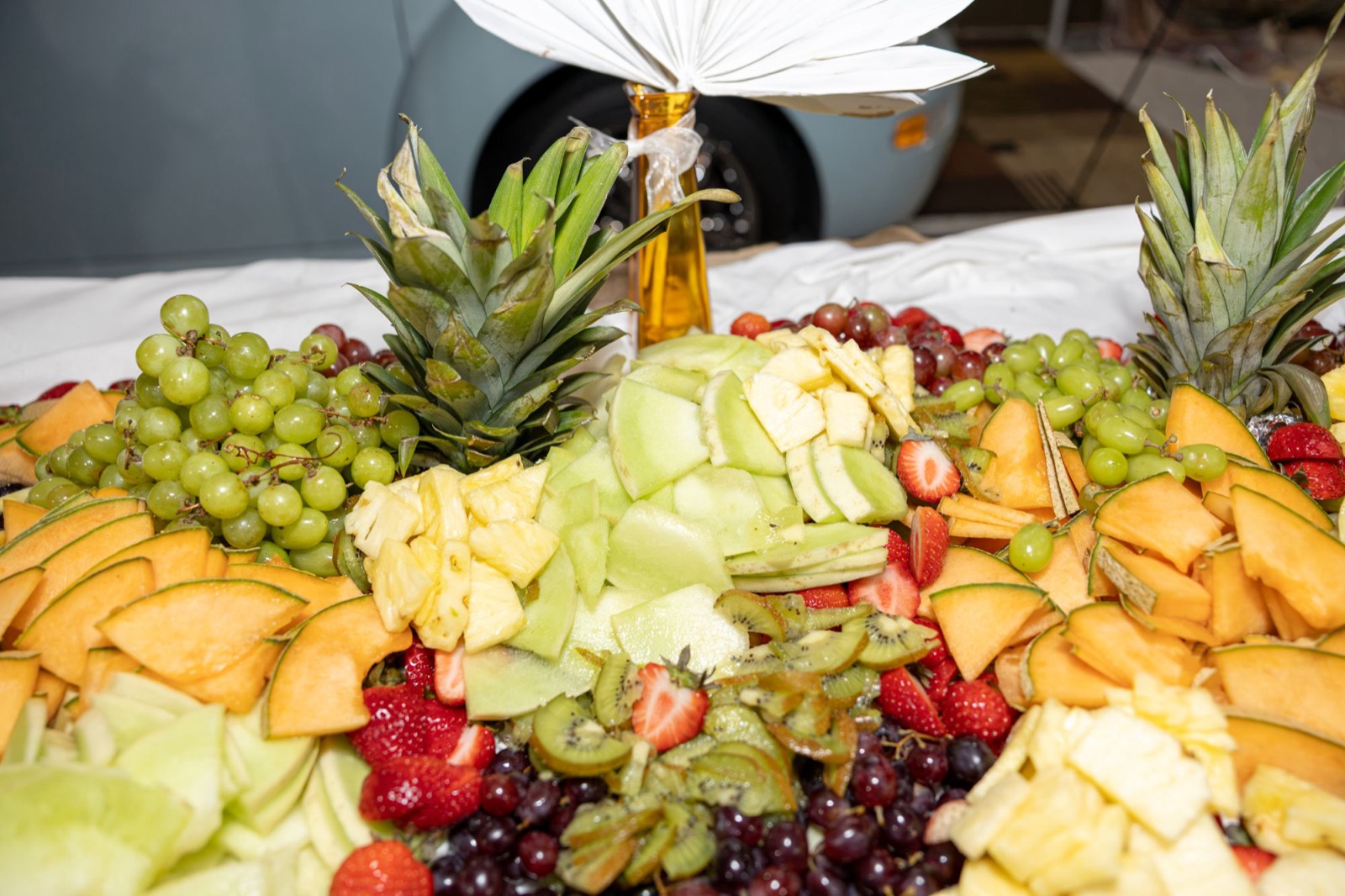 Fresh fruit platter with grapes, cantaloupe, honeydew, pineapple, strawberries, and kiwi